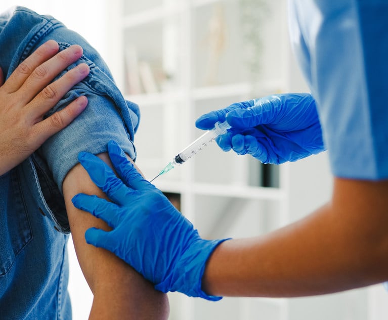 Nurse giving Covid-19 or flu antivirus vaccine shot to senior male patient 