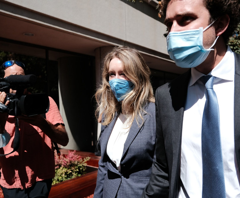 Elizabeth Holmes, founder of Theranos Inc., and husband Billy Evans exit federal court in San Jose, California, U.S., on Wednesday, Sept. 8, 2021. Holmes, 37, faces a dozen fraud and conspiracy counts that could send her to prison for as long as 20 years if shes convicted. Photo: David Odisho/Bloomberg