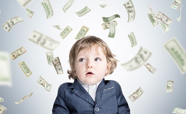 boy looking at cash flying around him