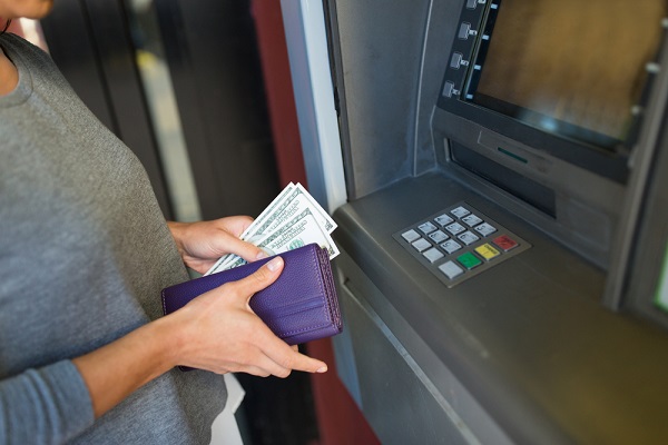 Woman getting cash at ATM