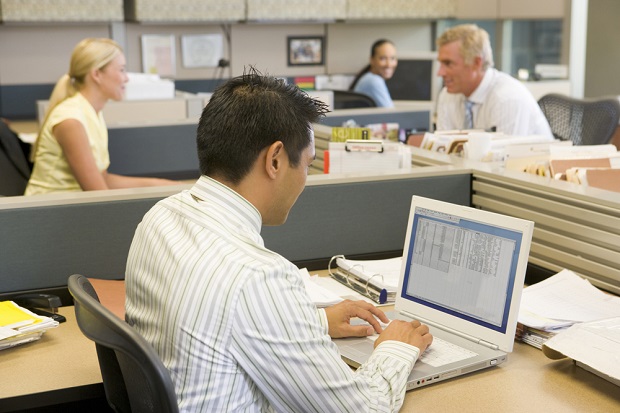 man in small firm's open office plan