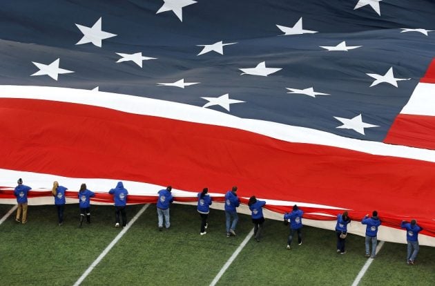 People unfurling giant U.S. flag