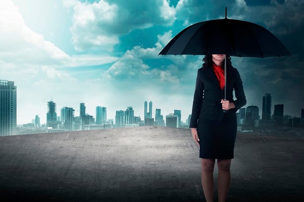 woman standing on roof with umbrella