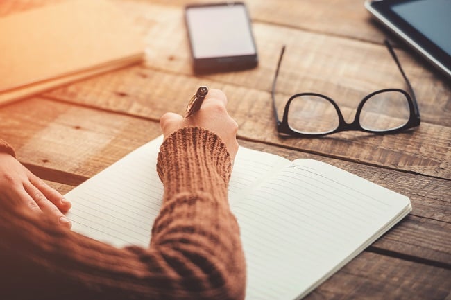 Woman writing on blank page