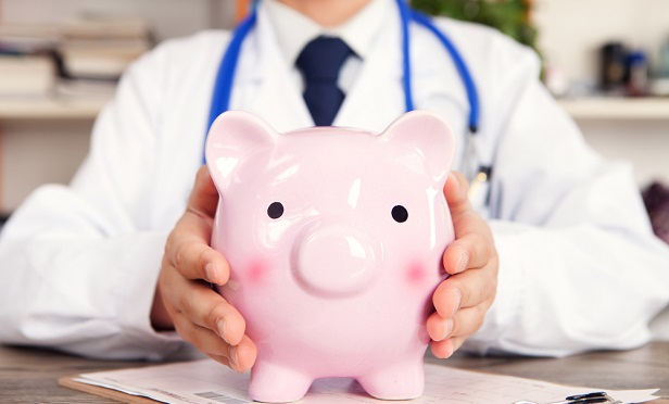 Doctor with piggy bank