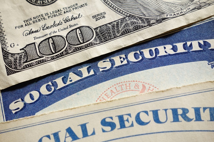 Social Security card atop money