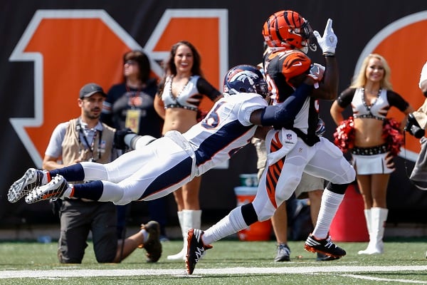 Denver football player tackling Cincinnati player