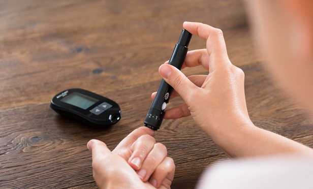 Person testing blood sugar