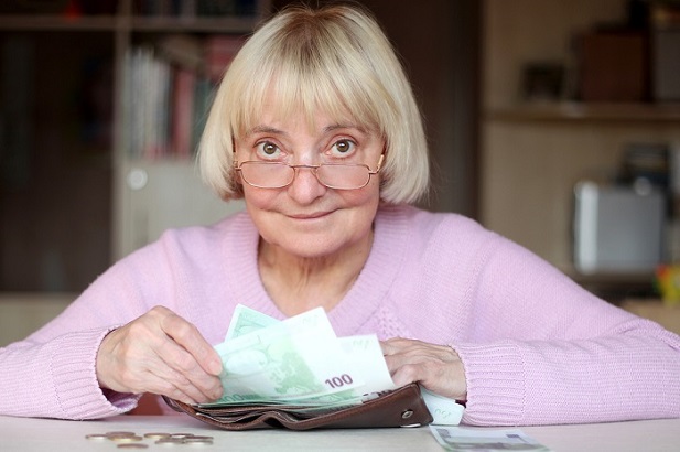 smiling older woman with money