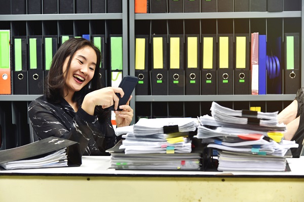 Woman on phone with feet on desk