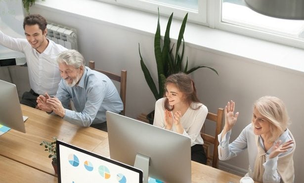 older and younger workers at computers