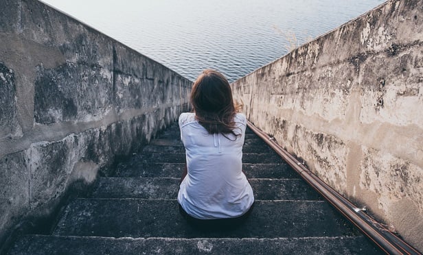 Woman sitting on stairs