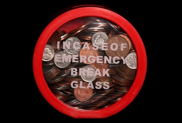 coins behind glass with words In Case of Emergency Break Glass