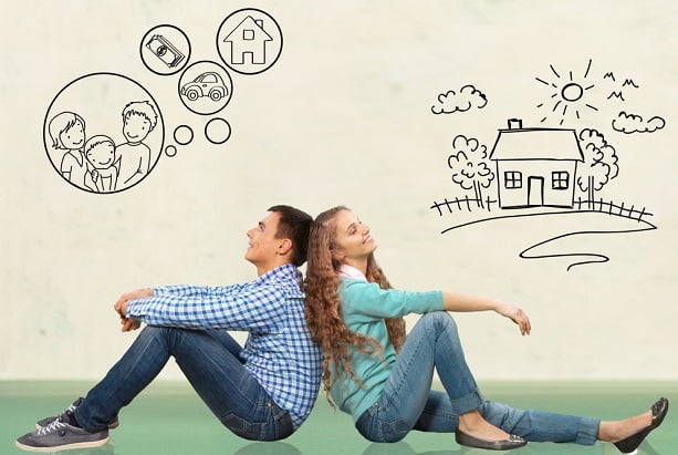 man and woman sitting back to back dreaming about buying home