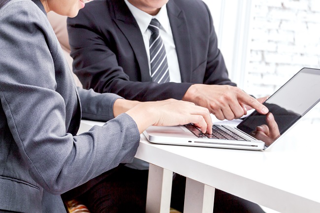 business man and woman looking at papers