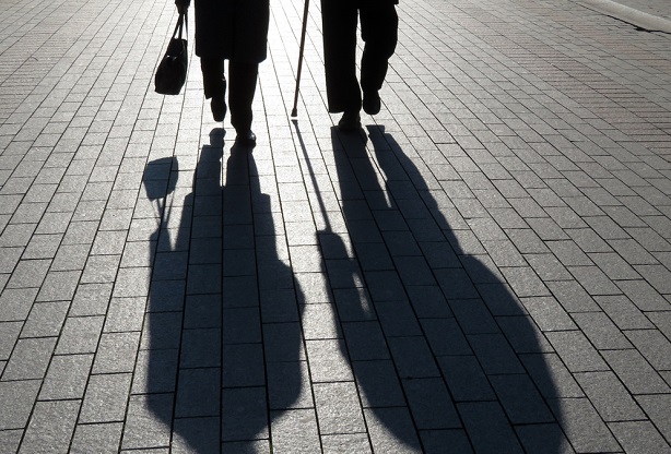 shadows of two older people walking