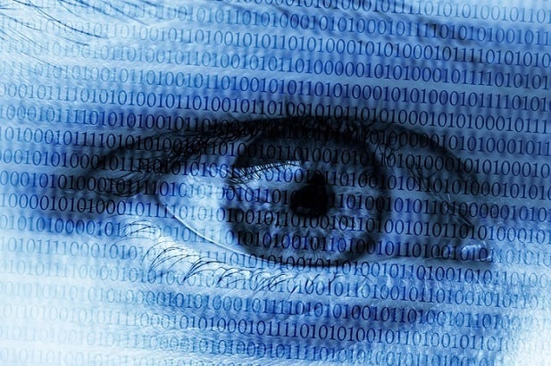 closeup of human eye with data code superimposed over it