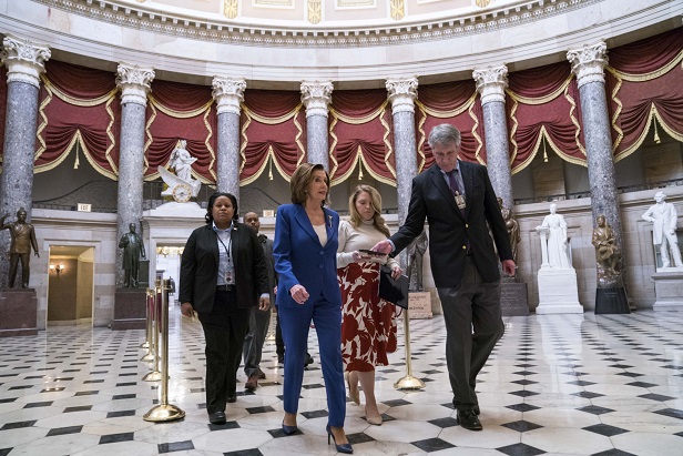 U.S. House Speaker Nancy Pelosi, a Democrat from California, center, arrives to the U.S. Capitol in Washington, D.C., U.S., on Friday, March 27, 2020. The House passed the $2 trillion coronavirus rescue plan Friday and will send it to President Donald Trump for his signature. One person voted against it: GOP Rep. Massie of Kentucky.