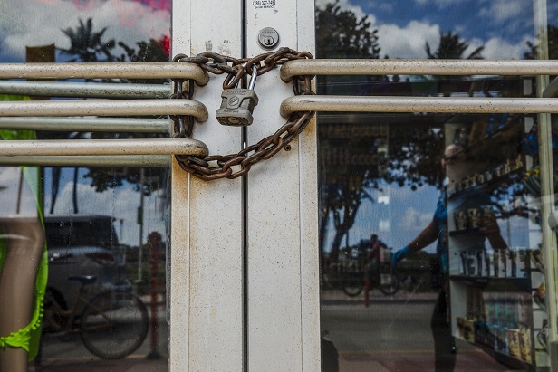 A lock and chain secure the door of a closed store in the South Beach neighborhood of Miami Beach, Florida, U.S., on Friday, March 20, 2020.