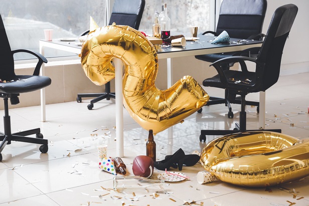 office after New Year's party with trash, tumbled 2020 balloons