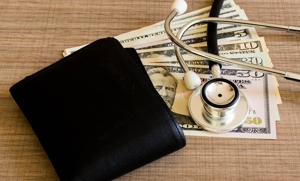 Wallet, cash bills and stethoscope 