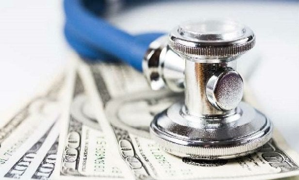 Stethoscope on dollars