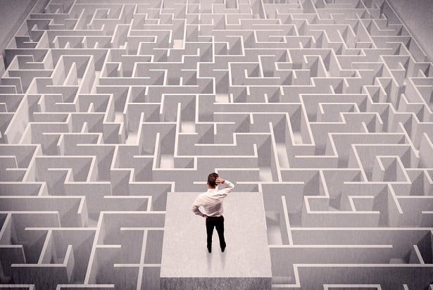 man standing above maze