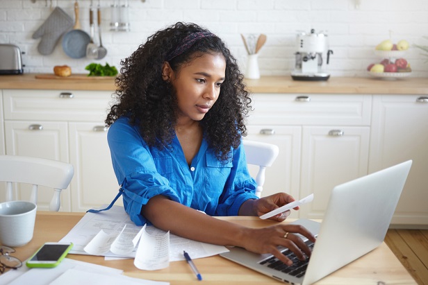 009 woman home tech laptop tax financial