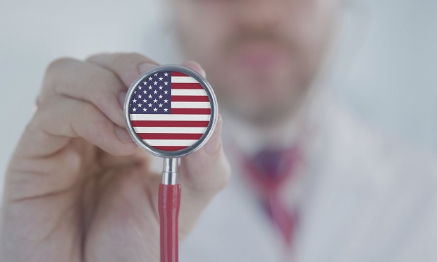 Doctor holding stethoscope with American flag