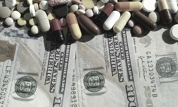 Pills scattered on $100 bills