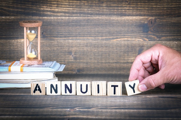 hand using letter cubes to spell out annuity