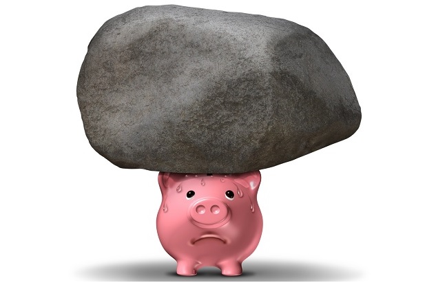 Pink piggy bank sweating under load of giant rock