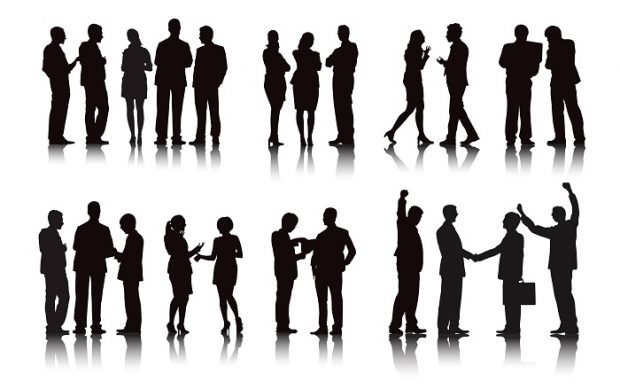various silhouettes of business women and men shaking hands and talking