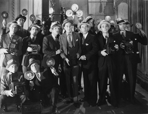old black and white photo of male reporters in suits and hats