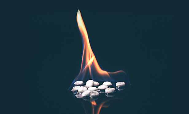 Flame on pile of pills