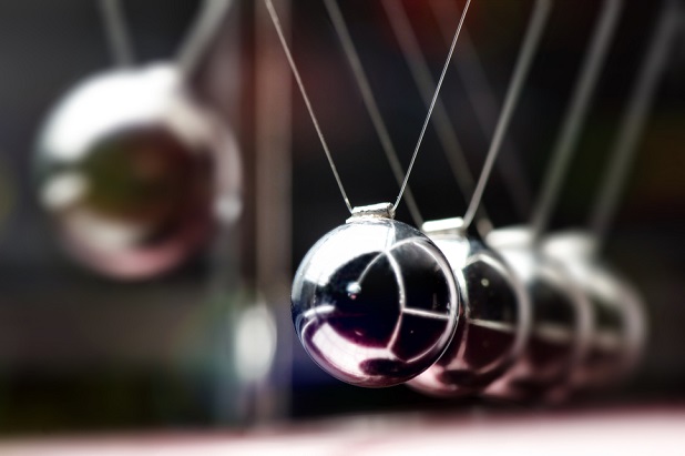 suspended steel ball striking a series of suspended steel balls