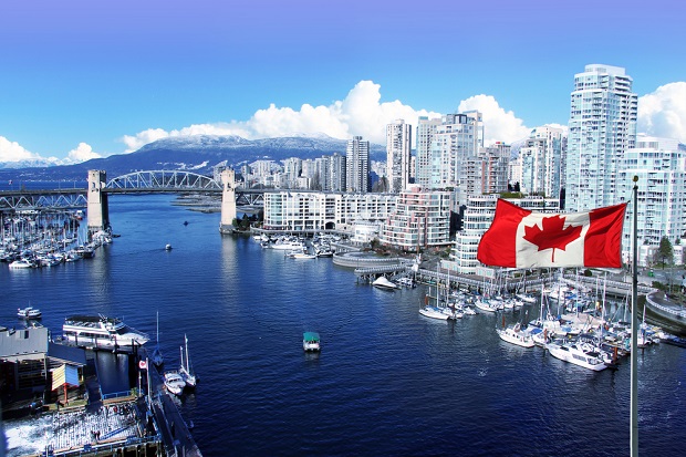 Vancouver BC city and harbor with Canadian flag