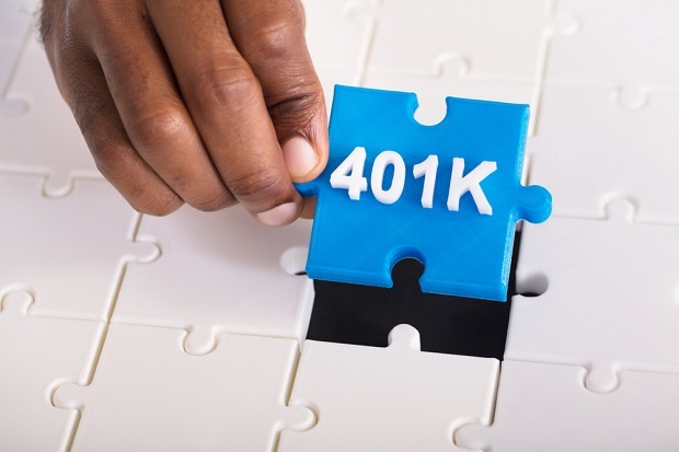 hand placing puzzle piece marked 401k