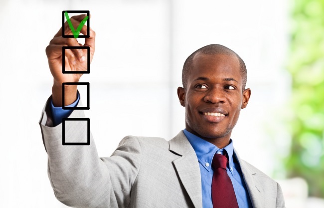 man in business suit checking check boxes on glass
