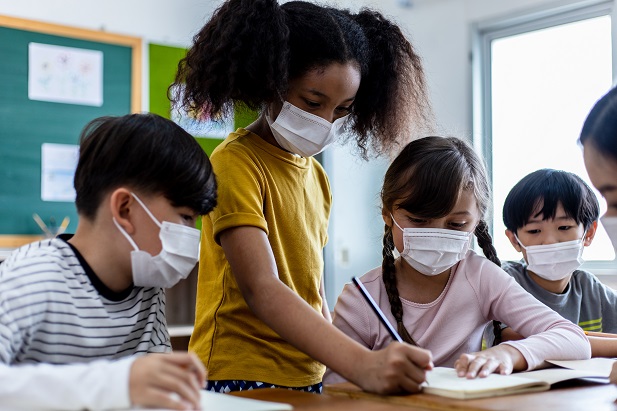 masked children in classroom learning