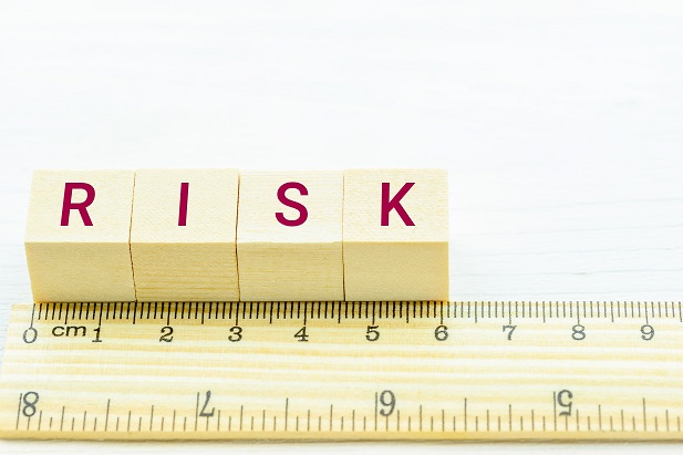 ruler with letter tiles spelling out Risk
