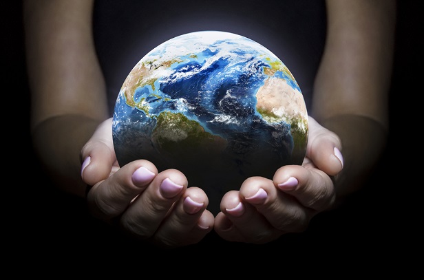 hands holding tiny model of Earth