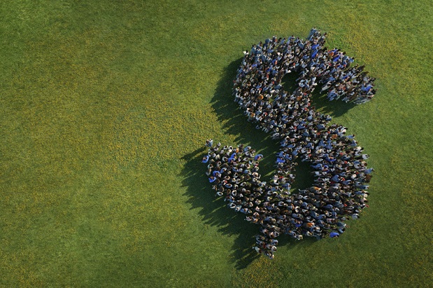 group of people seen from above forming a dollar sign