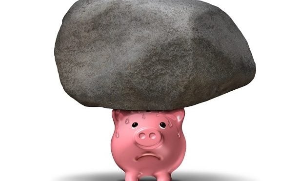 pink piggy bank with heavy rock on top