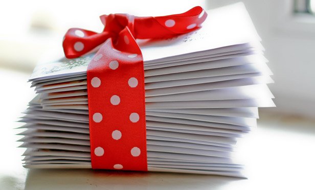 stack of envelopes with ribbon around it