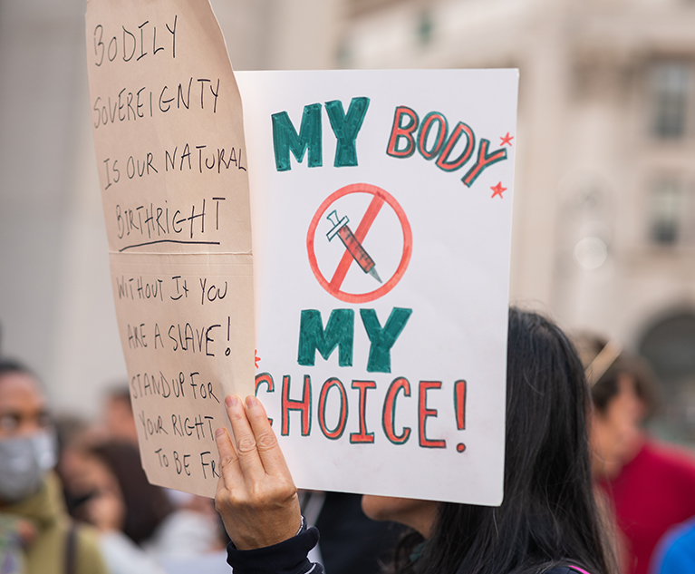 Woman holding my body my choice protest sign