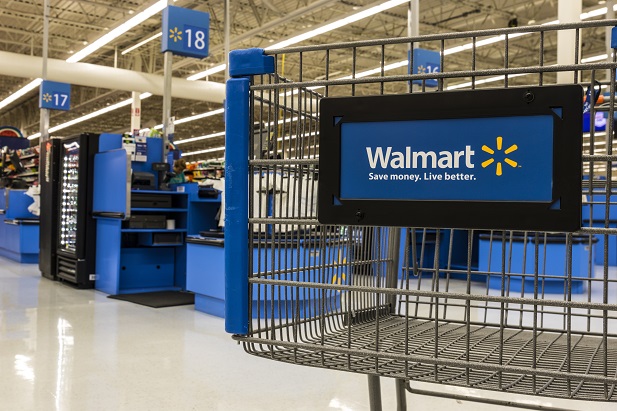 closeup of Walmart cart with checkout stands in background