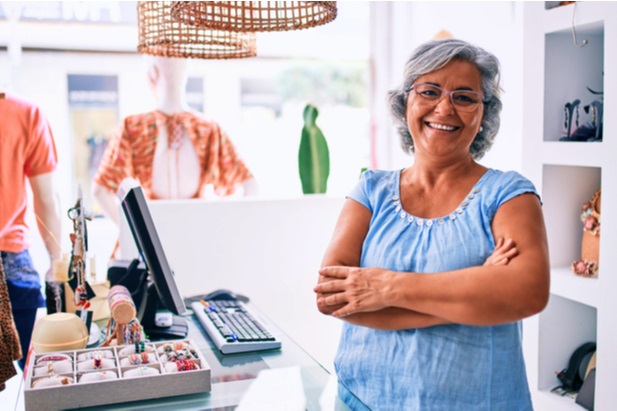 older woman in retail store smiling at camera