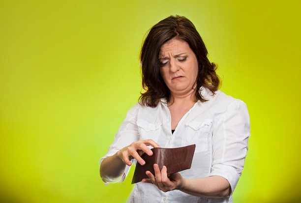 woman frowning as she looks in her wallet