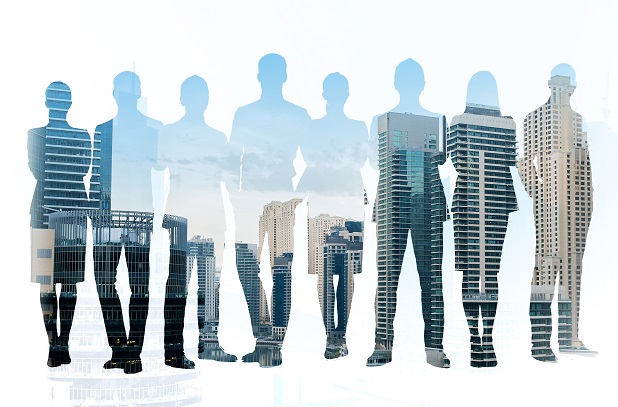 business people in silhouette with skyscrapers collaged in their shapes